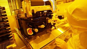 Inspection of the optical wafer stepper in the cleanroom.